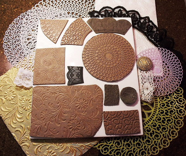 To make these textured stamps I used plastic doilies, textured scrapbook paper, lace, a bead.